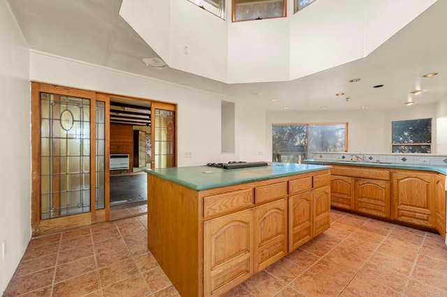 kitchen with a center island, sink, and light tile patterned floors