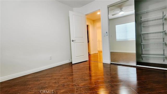 unfurnished room with dark hardwood / wood-style floors and ceiling fan