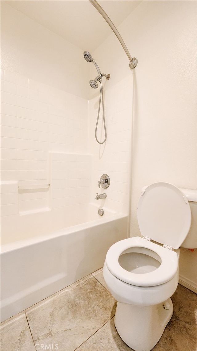 bathroom featuring tile patterned floors, tub / shower combination, and toilet