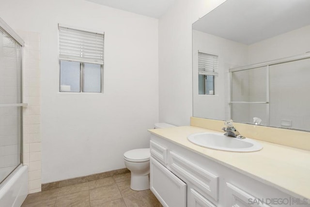 full bathroom with tile patterned floors, vanity, toilet, and enclosed tub / shower combo