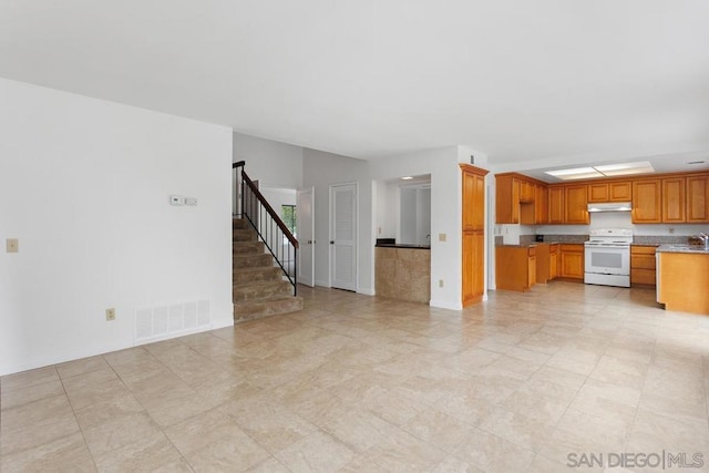 kitchen featuring white electric stove and sink