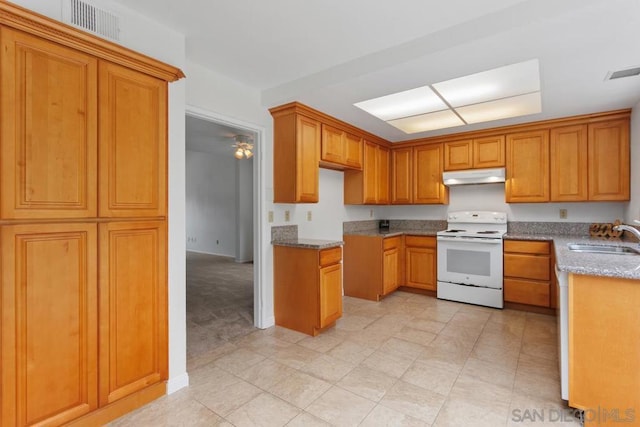 kitchen featuring sink, white electric range oven, and light stone counters