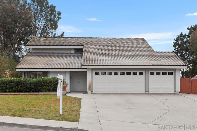 front of property with a garage and a front yard