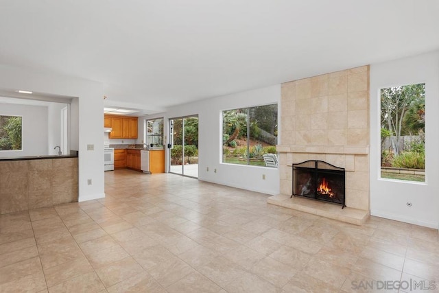 unfurnished living room with a tile fireplace