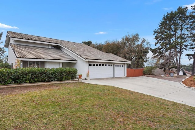 view of front facade with a garage and a front lawn