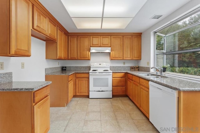 kitchen featuring light stone counters, sink, white appliances, and light tile patterned floors