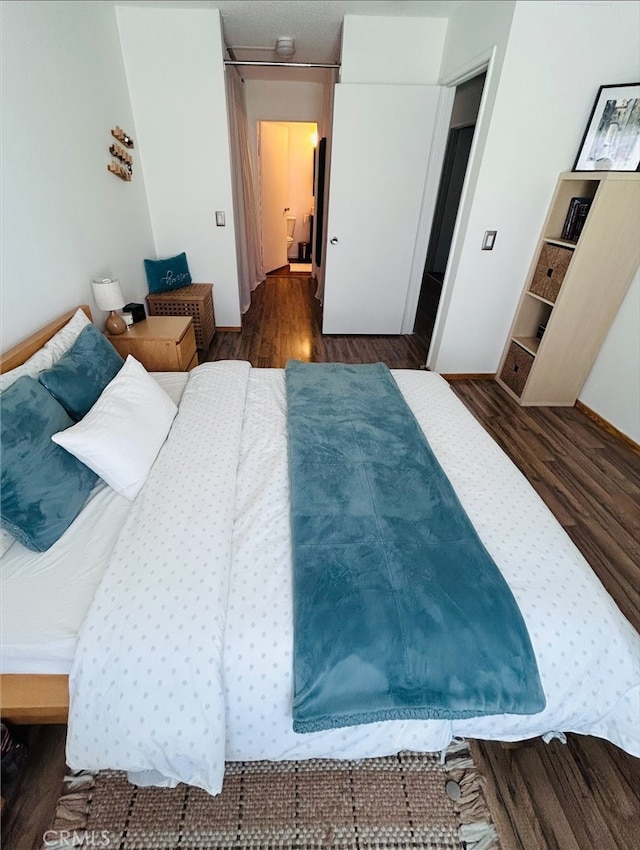 bedroom featuring dark wood-type flooring