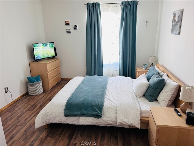 bedroom with dark wood-type flooring