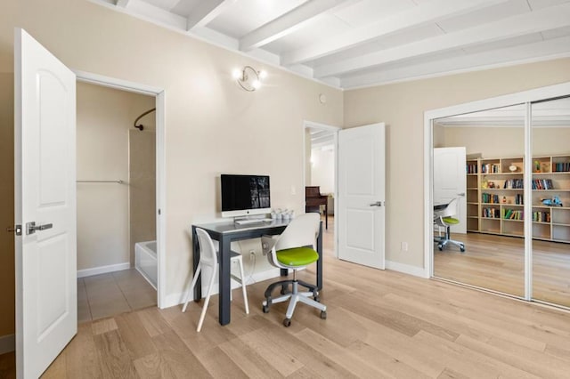 office featuring light hardwood / wood-style floors and beamed ceiling