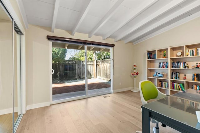 home office featuring vaulted ceiling with beams and light hardwood / wood-style flooring