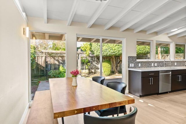 sunroom / solarium with sink, a wealth of natural light, and beam ceiling