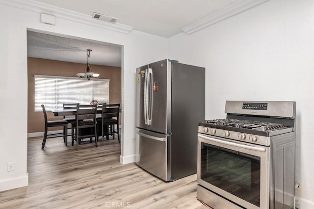 kitchen with light hardwood / wood-style flooring, appliances with stainless steel finishes, hanging light fixtures, ornamental molding, and a chandelier