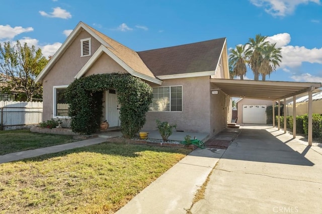 view of front facade with a carport, a garage, and a front yard