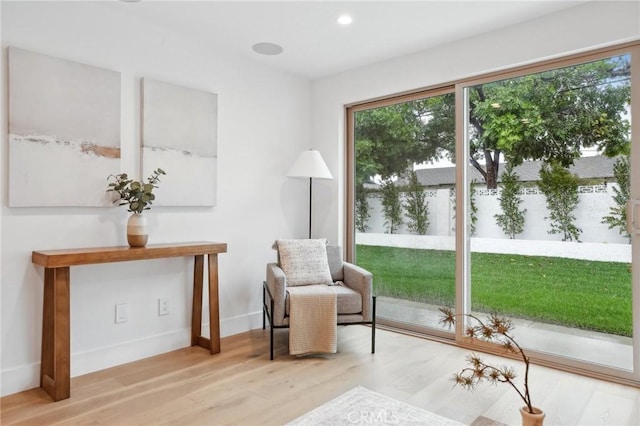 sitting room with recessed lighting, baseboards, and wood finished floors