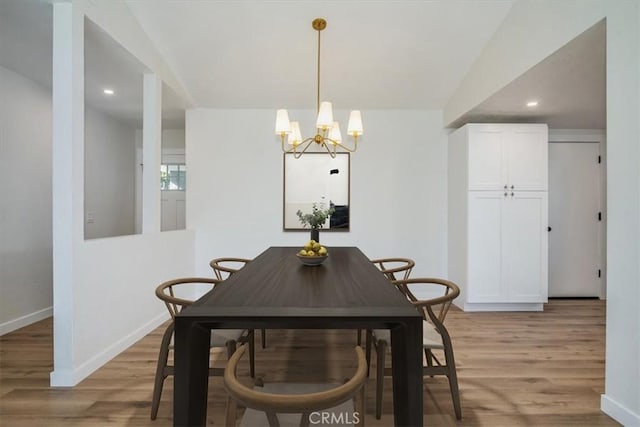 dining area with a notable chandelier and light wood-type flooring