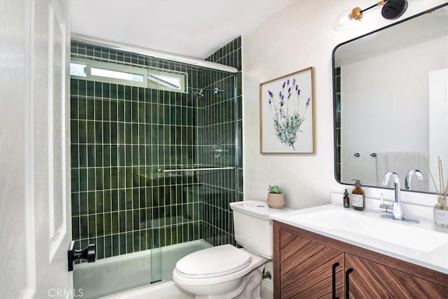 bathroom featuring vanity, toilet, and a shower with door