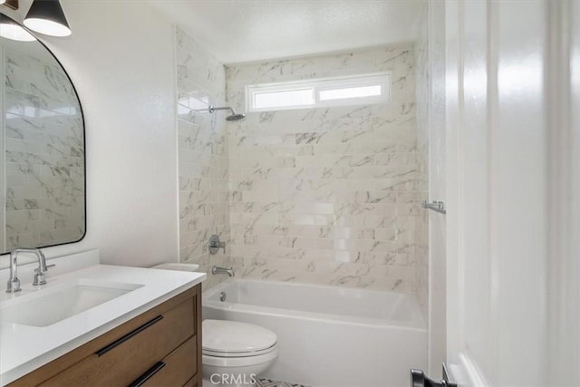 full bathroom featuring tiled shower / bath combo, vanity, and toilet