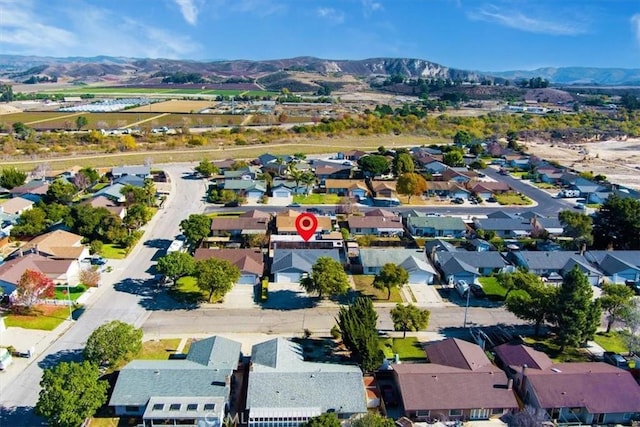 birds eye view of property featuring a mountain view