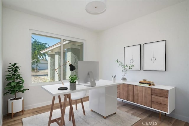 home office with hardwood / wood-style flooring and plenty of natural light