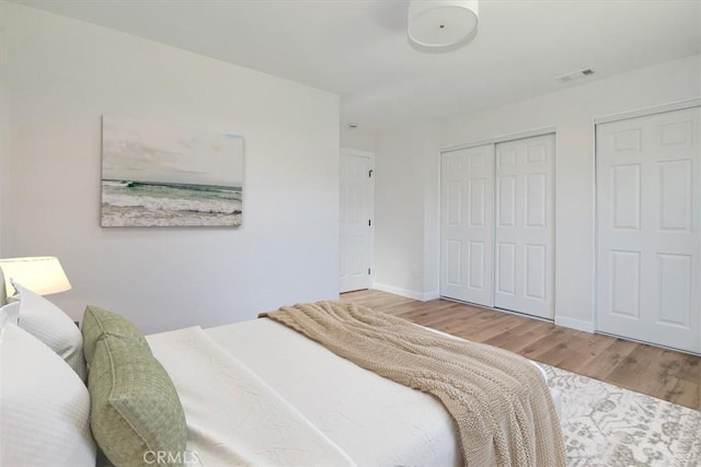 bedroom with hardwood / wood-style floors and a closet