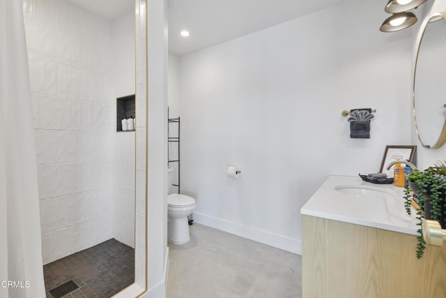 bathroom featuring vanity, concrete floors, toilet, and a tile shower