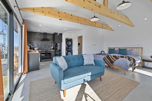 living room with stacked washer and dryer and lofted ceiling with beams