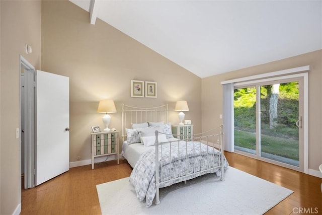 bedroom featuring wood-type flooring, access to exterior, high vaulted ceiling, and beam ceiling