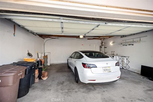 garage with a garage door opener and gas water heater