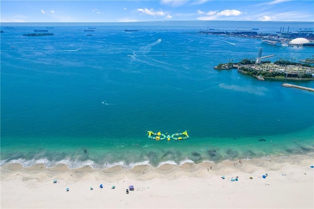 birds eye view of property with a view of the beach and a water view