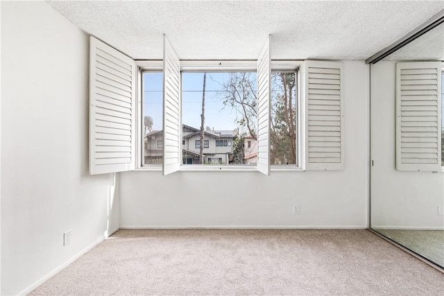 unfurnished bedroom with light carpet and a textured ceiling