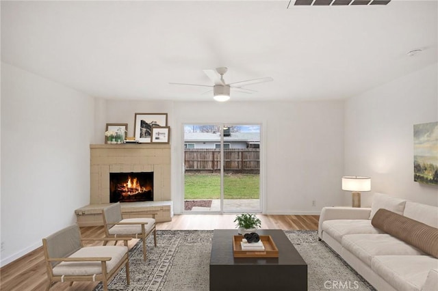 living room featuring hardwood / wood-style floors and ceiling fan