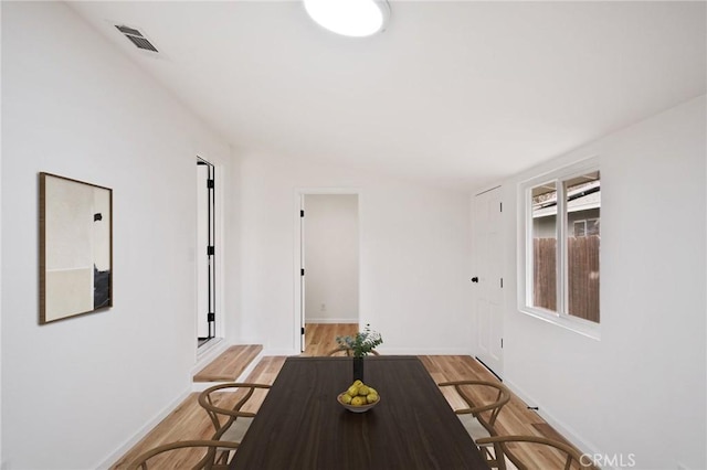 unfurnished dining area featuring light wood-type flooring