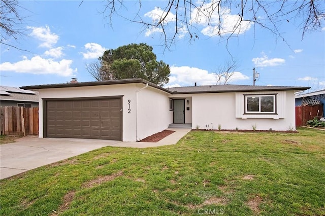 single story home featuring a garage and a front lawn