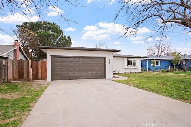 ranch-style house featuring a garage and a front lawn