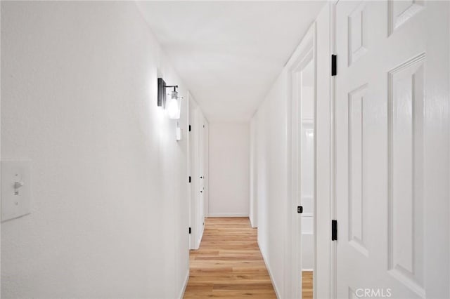 corridor with light hardwood / wood-style flooring