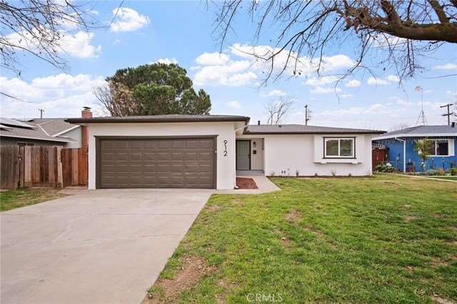 single story home featuring a garage and a front yard