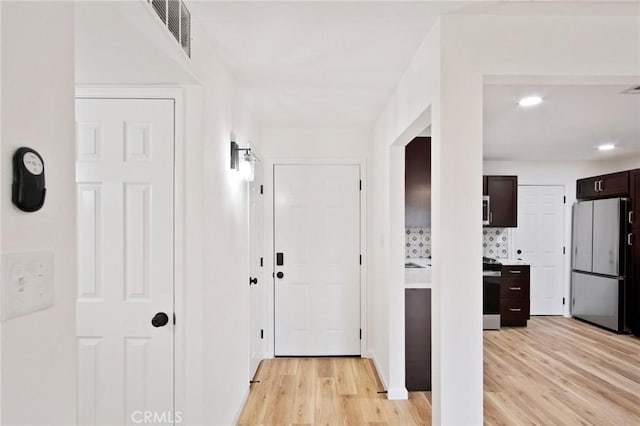 hallway with light hardwood / wood-style flooring