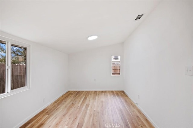 empty room with light hardwood / wood-style flooring