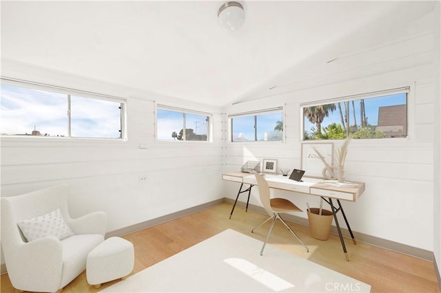 home office with hardwood / wood-style flooring and vaulted ceiling