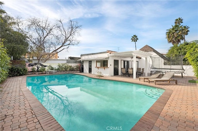 view of swimming pool with a pergola, a patio area, and a diving board