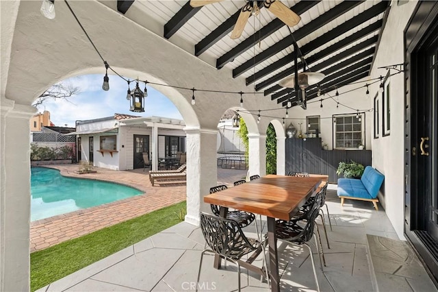 view of patio / terrace with a fenced in pool, exterior bar, and ceiling fan