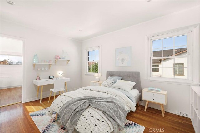 bedroom with hardwood / wood-style floors