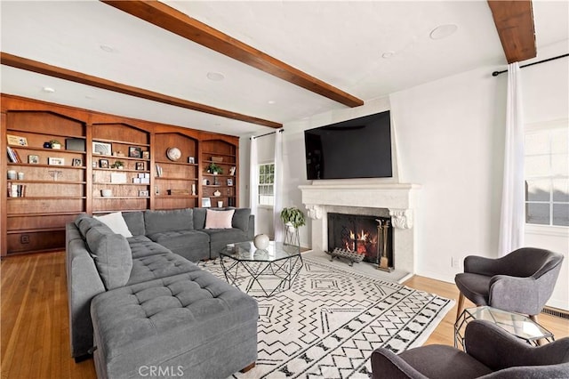 living room featuring light hardwood / wood-style floors and beamed ceiling