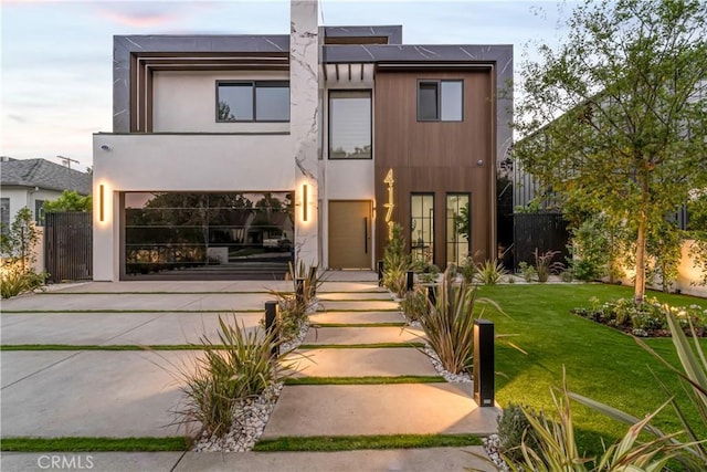 contemporary house with a garage and a yard