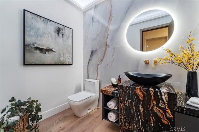 bathroom featuring hardwood / wood-style flooring, sink, and toilet