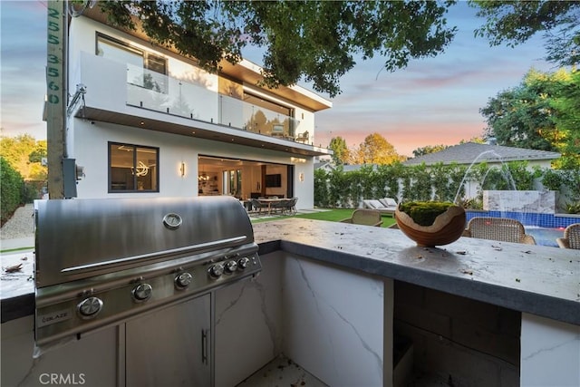 patio terrace at dusk with area for grilling