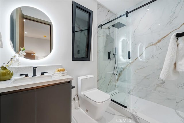 bathroom featuring vanity, toilet, and a shower with door