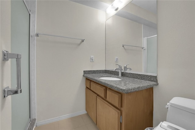 bathroom with vanity, toilet, an enclosed shower, and tile patterned flooring