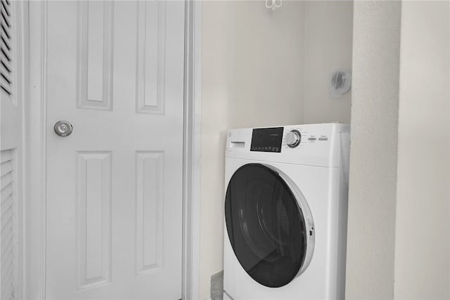 clothes washing area featuring washer / clothes dryer