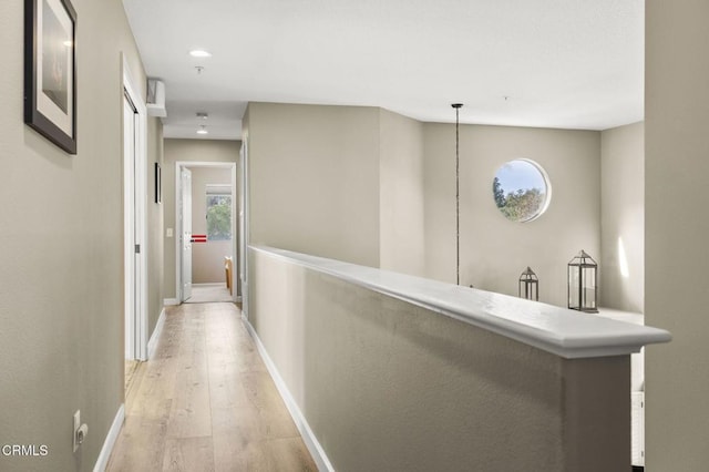 hallway with light hardwood / wood-style flooring